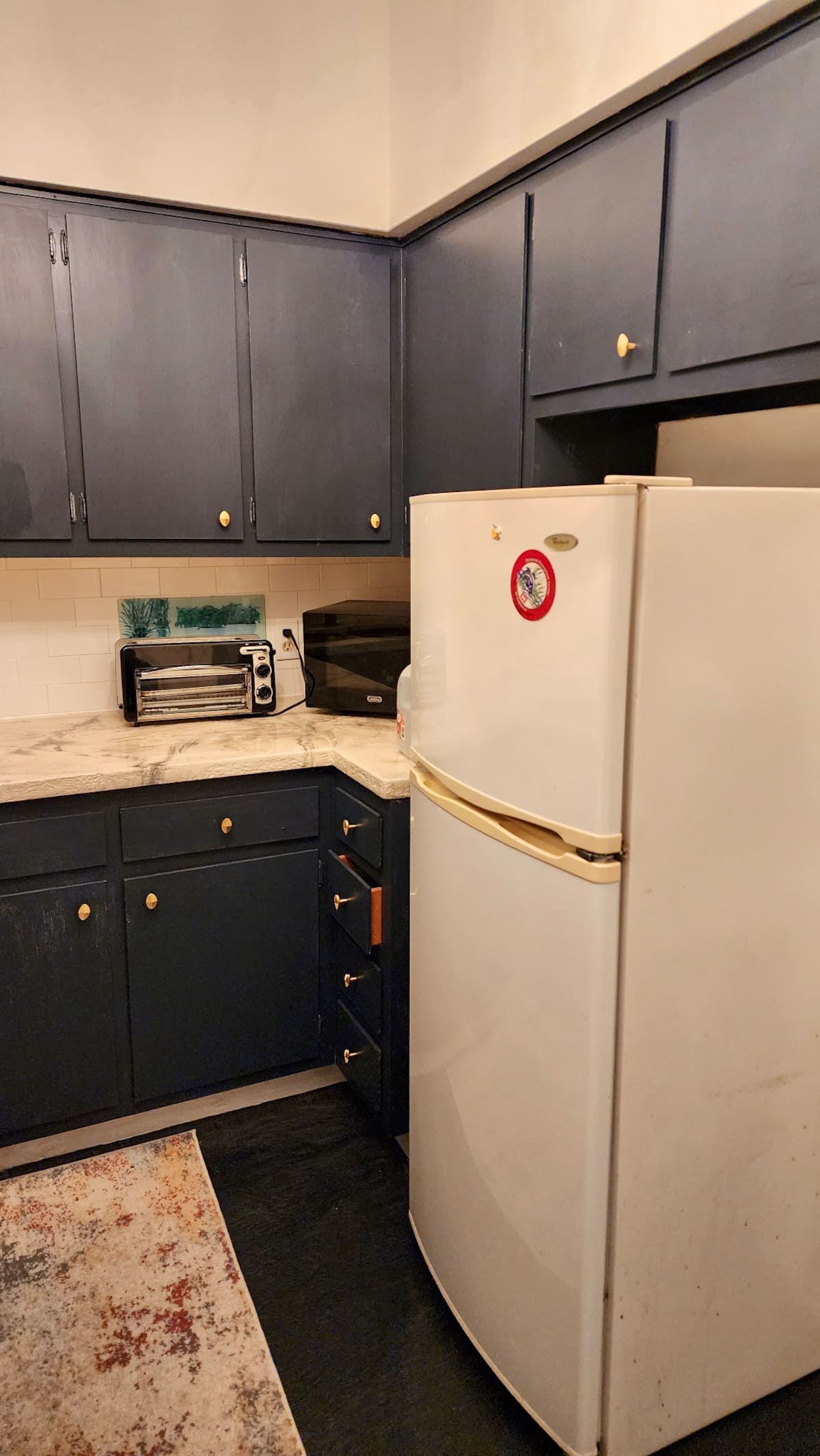 Full kitchen with navy cabinetry